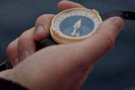 Hands holding a compass