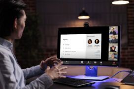 A man is sitting at a desk and using a computer.